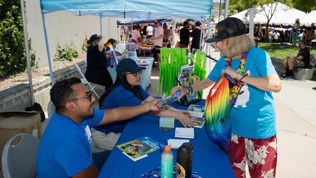 Women and LADWP booth receiving information from LADWP employees