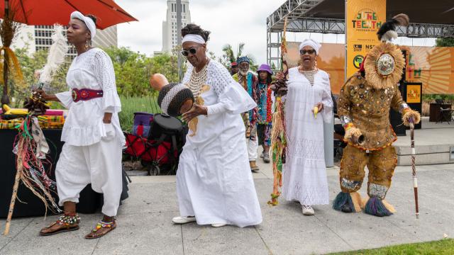 People singing and dancing at a Juneteenth event.