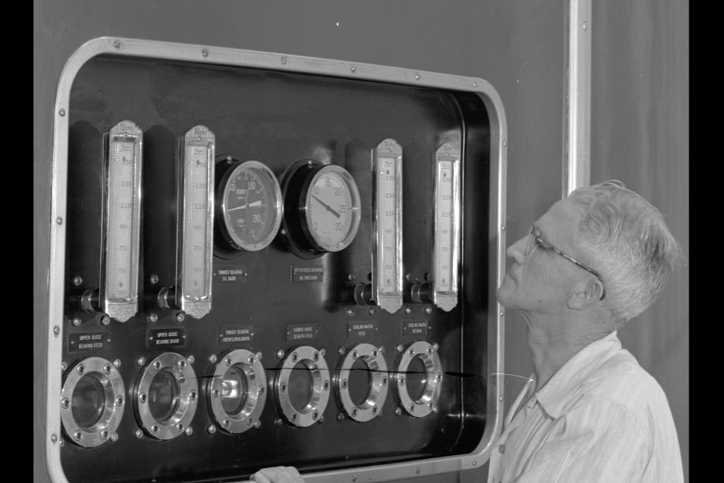 Man looking at power monitors