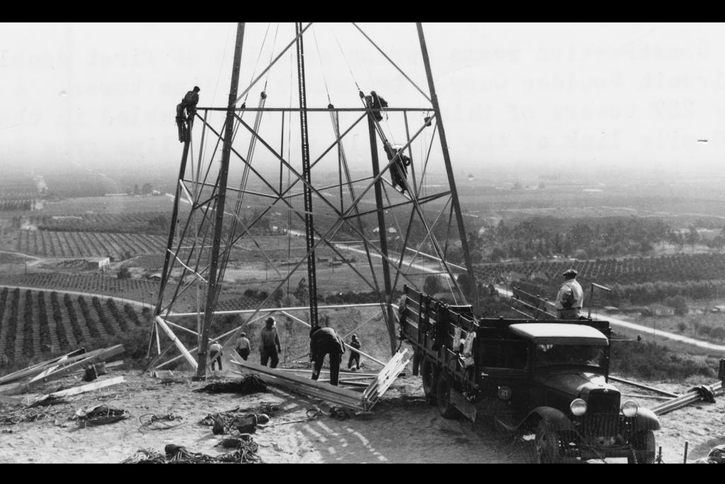 Men constructing power transmission tower