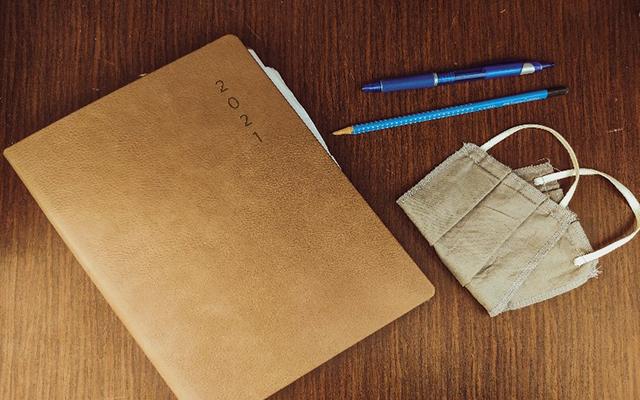 planning paperwork, pens, and masks
