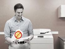 man in front of printer