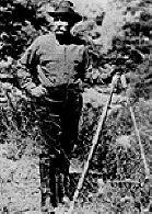 Photo of William Mulholland with survey scope in the field. 