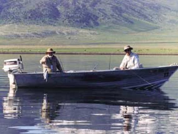 two men on a skiff boat on a lake