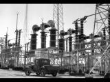 Pickup truck parked in front of power station