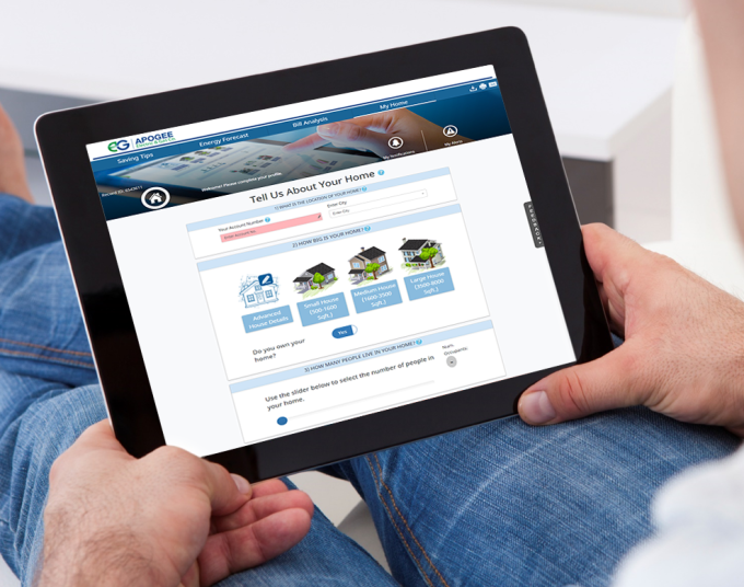 Man holding computer tablet that's resting on his legs. Text on the computer screen says Tell us about your home.