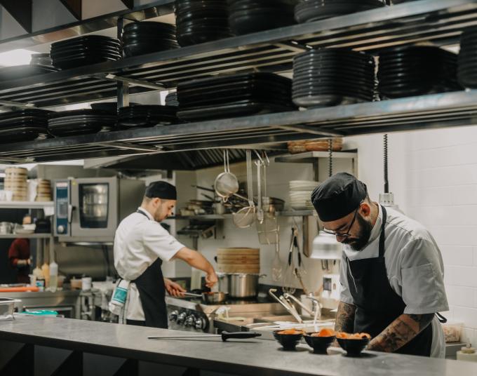 Two chefs working in a kitchen