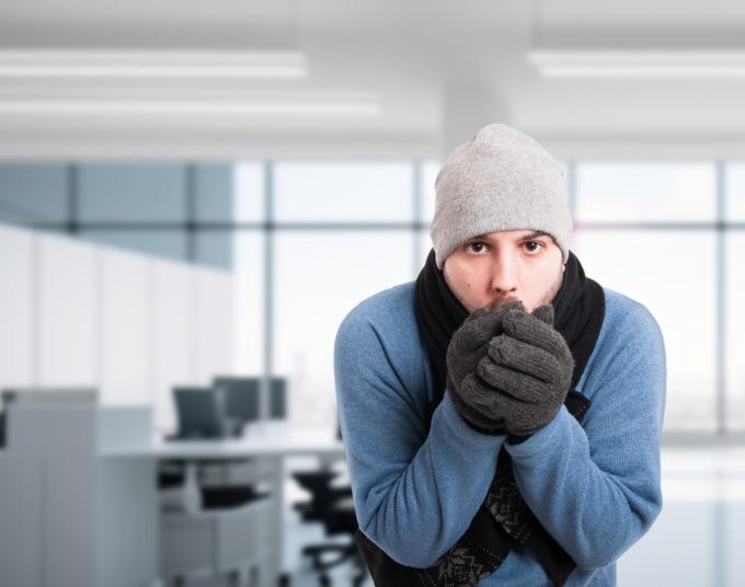 man dressed in winter clothes in office