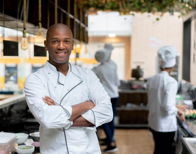 Man standing in restaurant kitchen