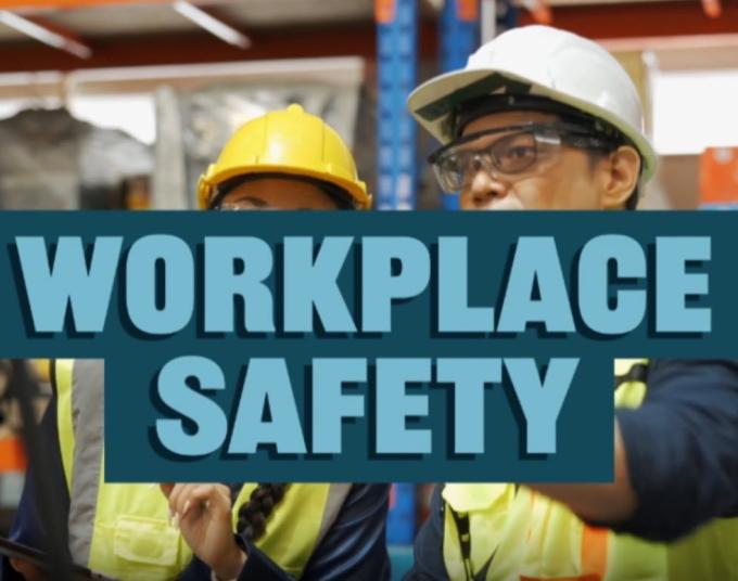 Two works in warehouse with hard hats with text that reads "Workplace Safety"