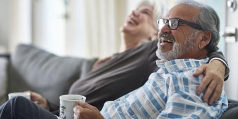  Woman with arm around laughing man