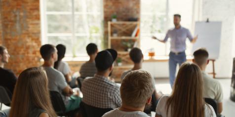 man speaking in front of audience