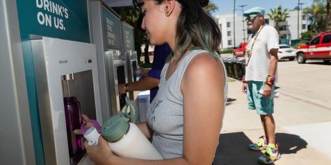 women filling up water bottle at hydration station