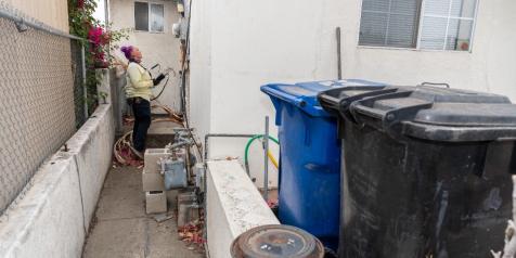 LADWP field worker looking at meter on house