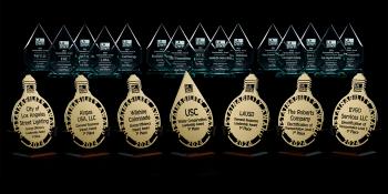 Seven first-place trophies and 14 second- and third-place trophies are displayed against a black background.